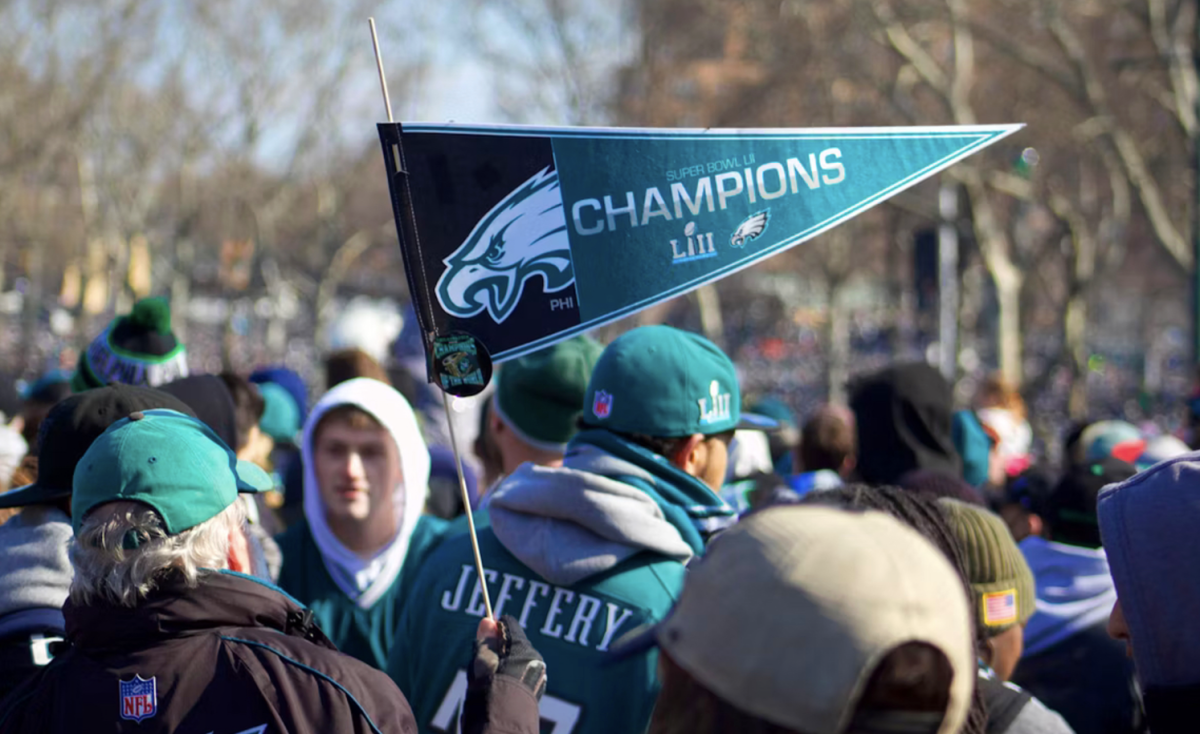 An Eagles fan holds up a flag to celebrate the team’s Super Bowl win in 2018.